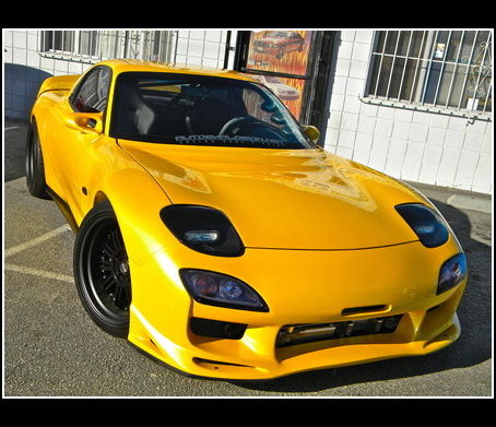 Yellow Mazda sports car outside the Gardena shop