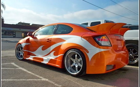 Orange Scion with contrasting painted graphics