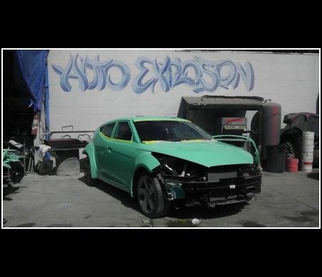 Green Puma vehicle body outside the shop